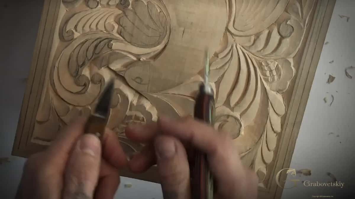Two carving knives held up together, the everyday number 12 in one hand and a much smaller blade in the other.