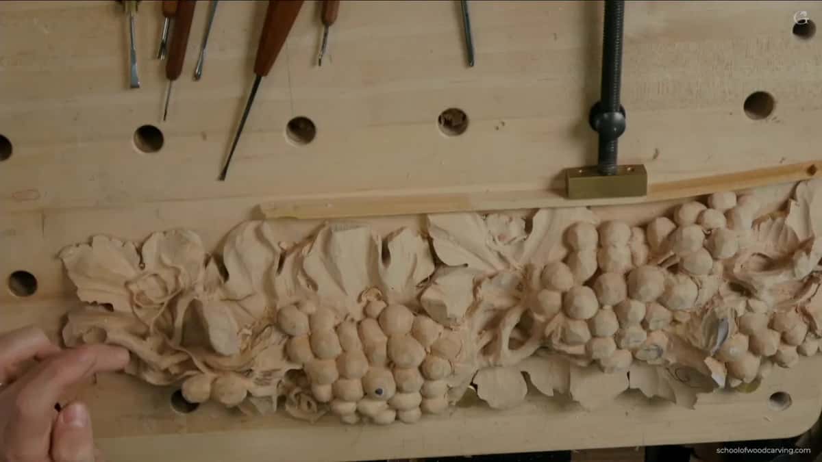 Panel from overhead with a hand at the lower edge, the strand still joined at several points