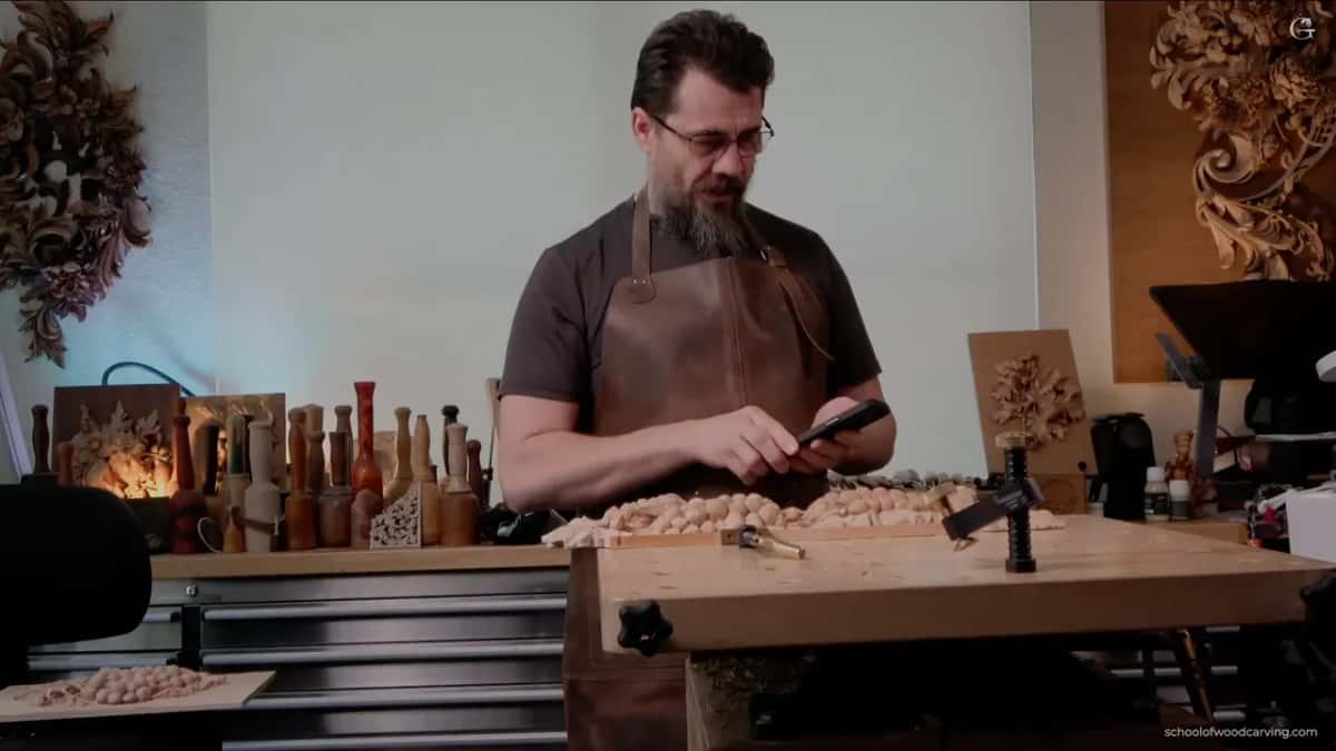 Alexander at the bench, tools racked behind him, showing the section he finished last time