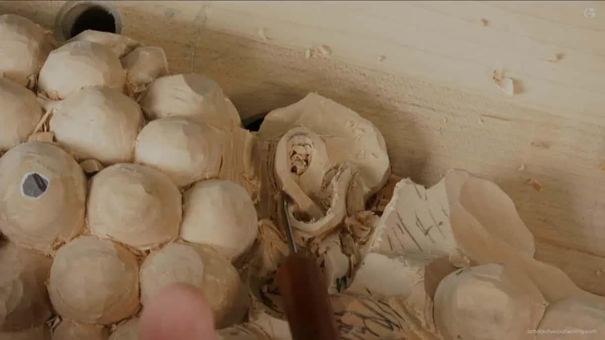 Brown handled gouge worked side to side inside a hollow too tight for a normal pass