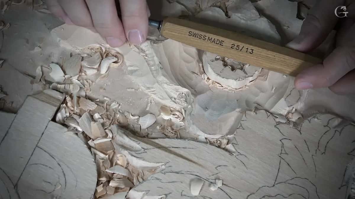 Handle stamped SWISS MADE 25/13 held over the work