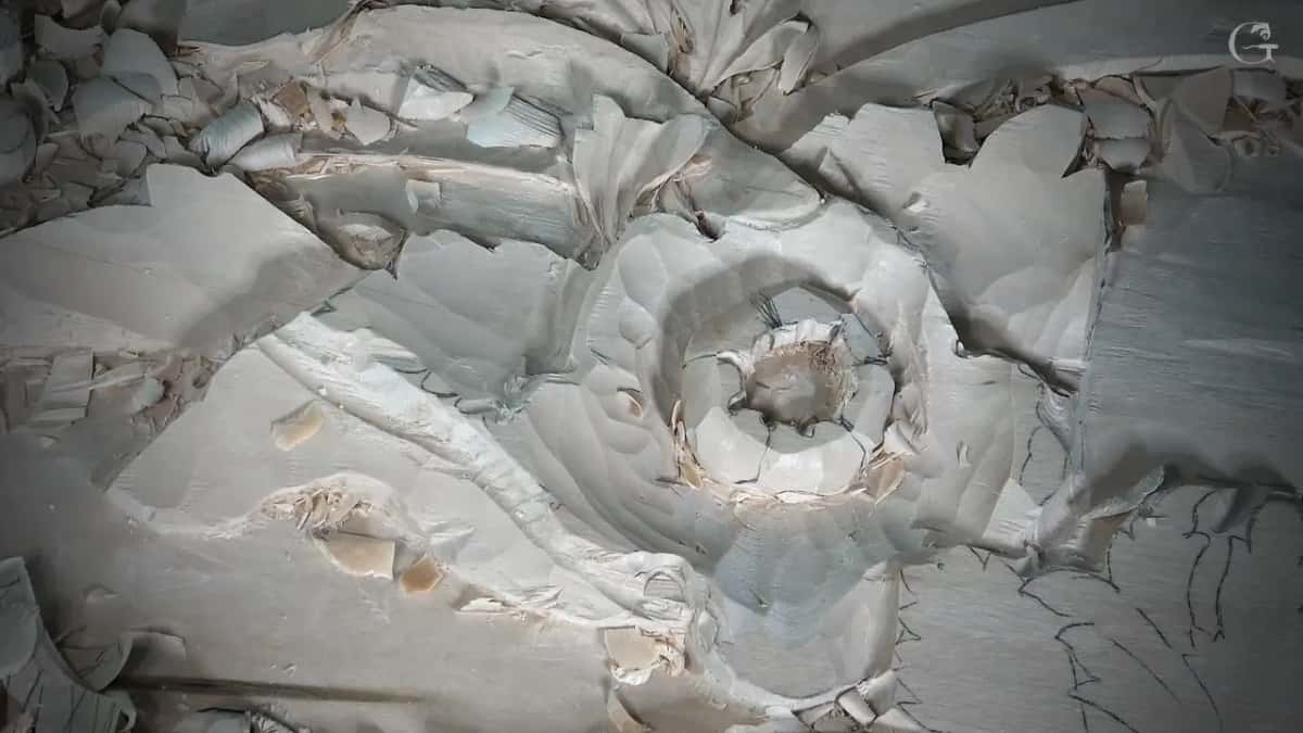 Five carved divisions run around a domed flower centre, each one slipping under the edge of its neighbour