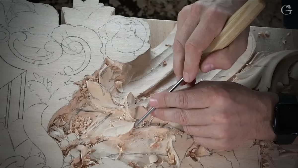 Two slim detailing tools worked together on tiny leaves, one hand pushing and one hand steering