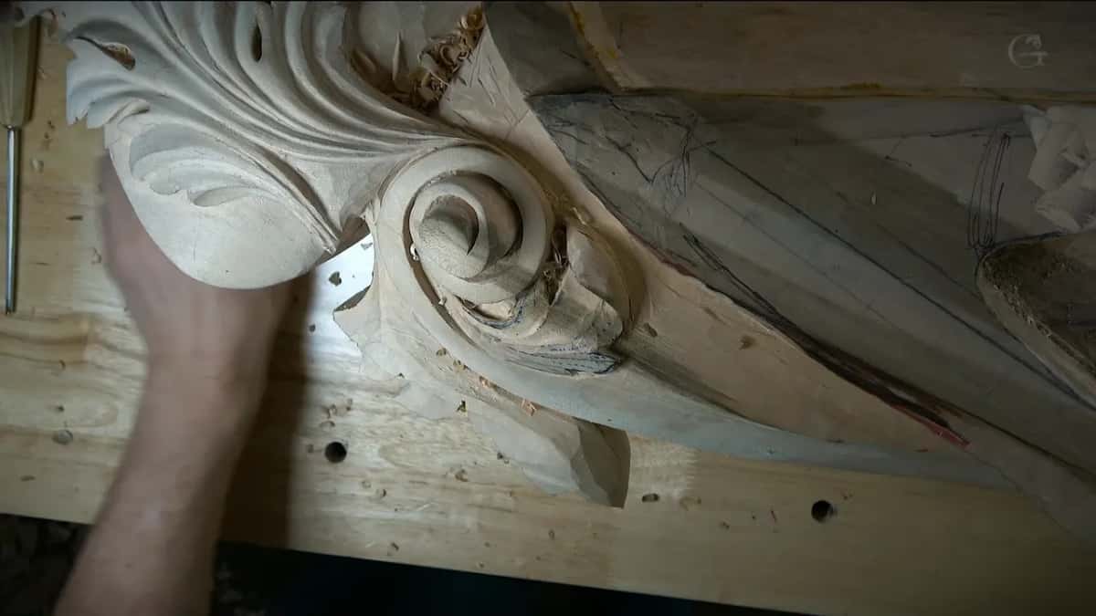 Raking light Raking light across the carved scroll and acanthus, pencil lines still on the uncarved part
