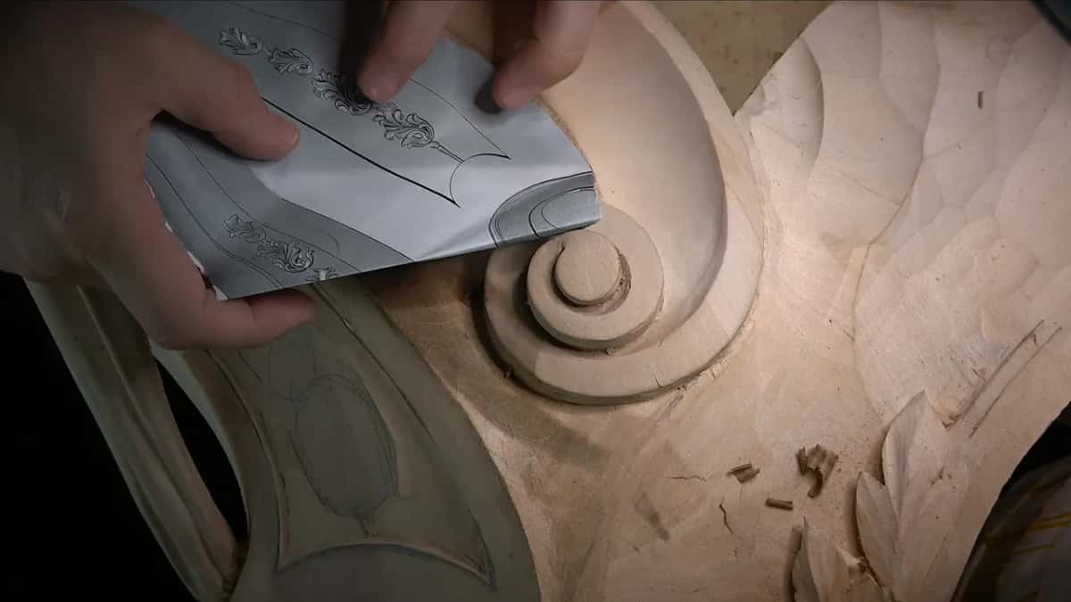 Too small in wood Paper printout of the design held up against the carved volute to compare the size