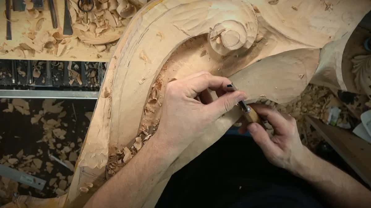Number 23 Hands on a light handled tool where the volute turns, gouges racked at the top left
