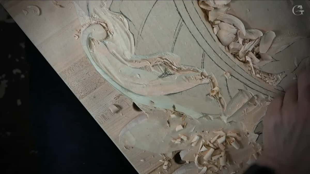 The long carved leaf once the high spots came off, curled shavings lying beside it