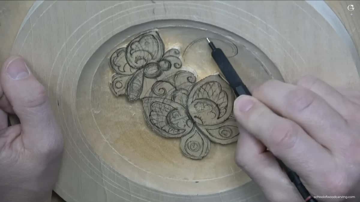 A fresh curl climbs toward the rim on the right, and the pencil tip is resting at its end