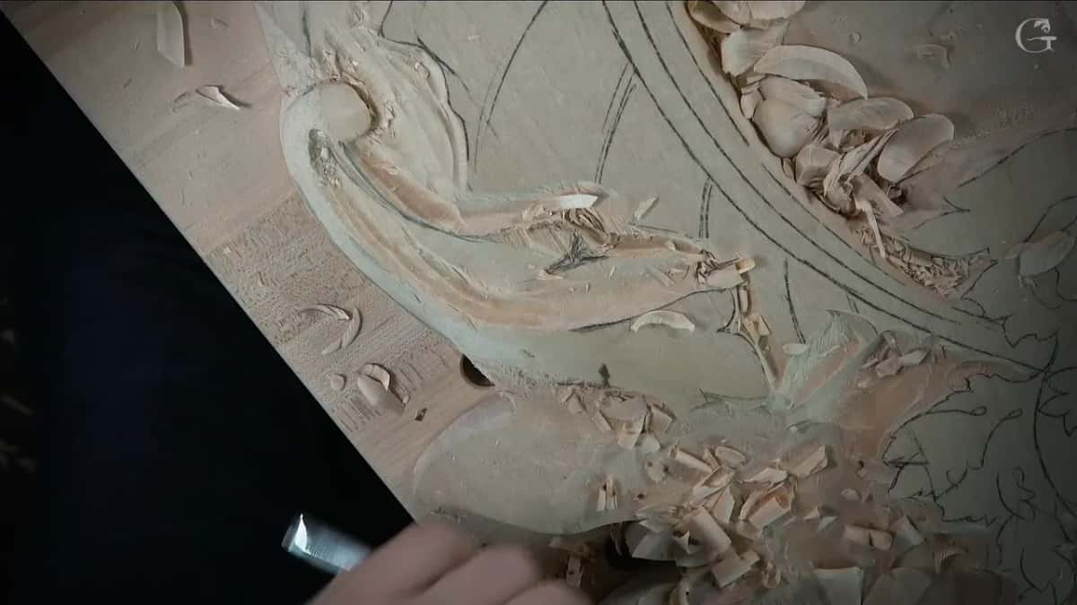 Long smooth curve running down out of the volute, the pencil design still drawn around it