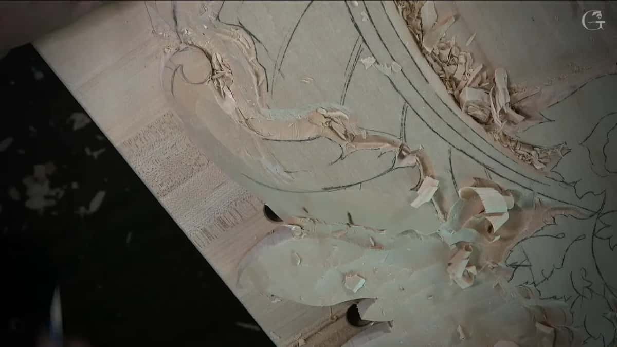 Shavings lying on the freshly sloped leaf and around the scroll
