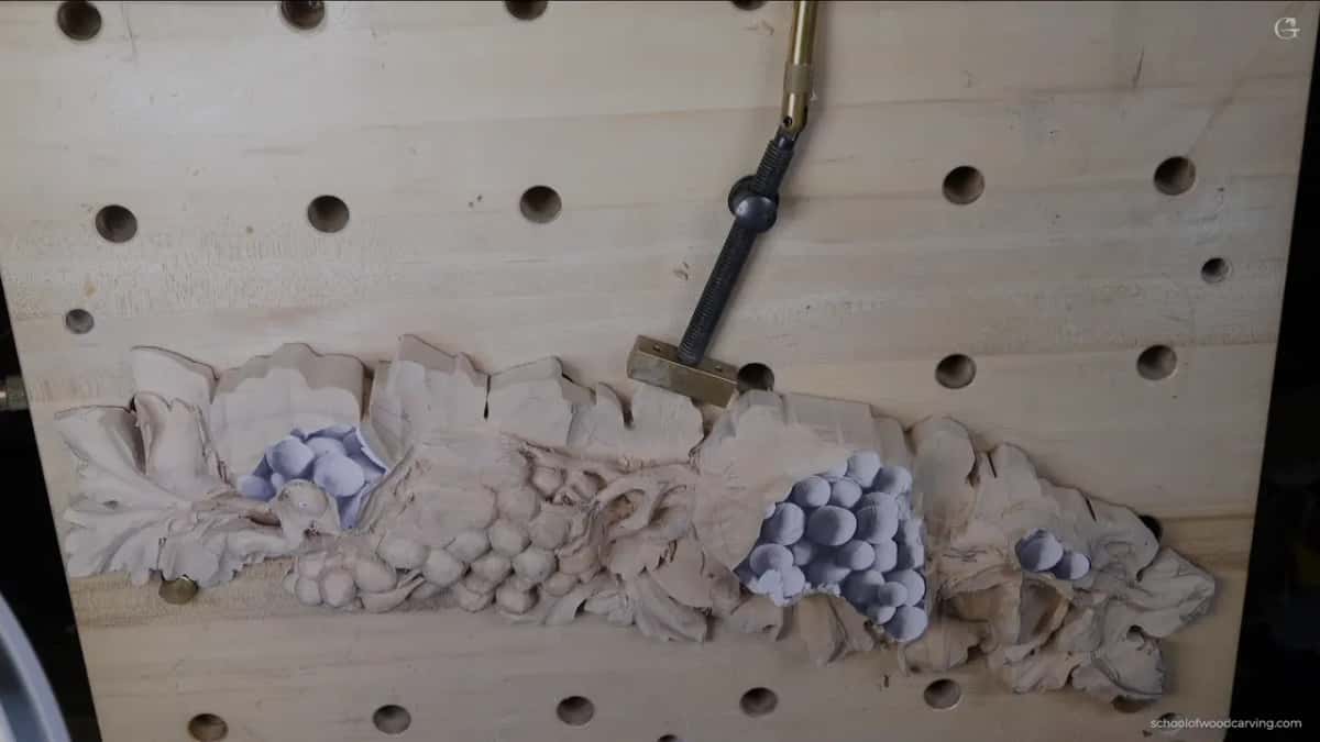 The whole board early on, one end carved and the far end still under its paper pattern