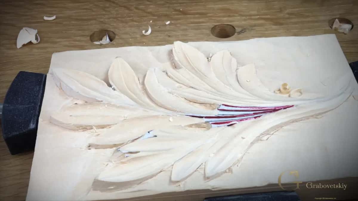 The finished leaf, every lobe carrying a hollow and a raised spine, red and blue lines still visible at the center.
