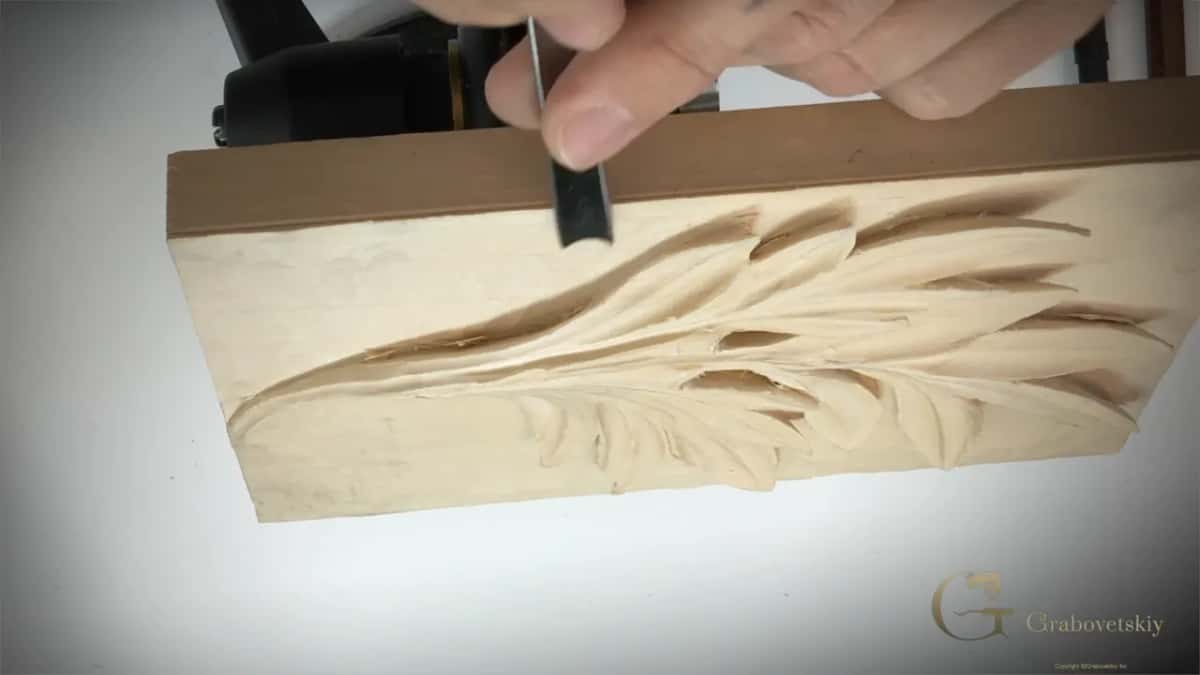 Pale fresh wood shows on the left where the ground has started coming down, tool at the top edge.