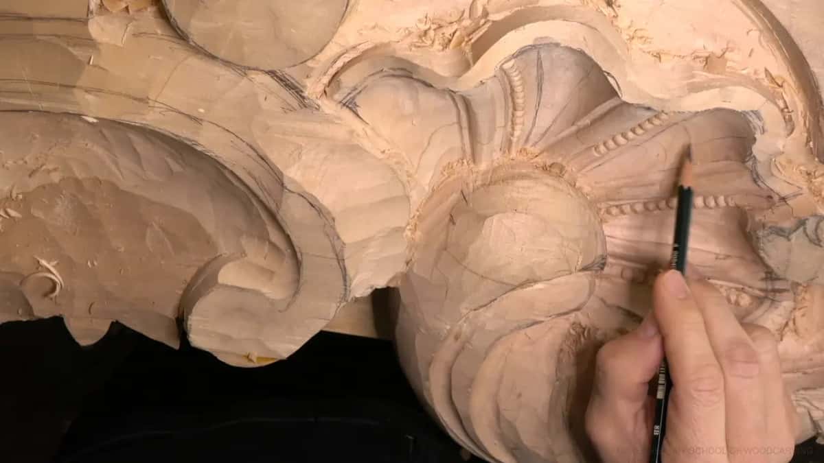 A pencil marks a new line inside the hollow, just below the carved beads and the rounded boss.