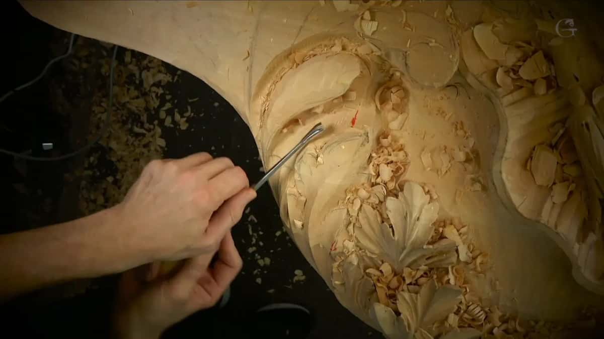 A long thin tool goes deep, two hands guiding it.