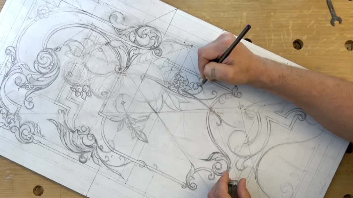 Pencil at a small flower beside the right hand scrolls, a wrench lying on the bench above