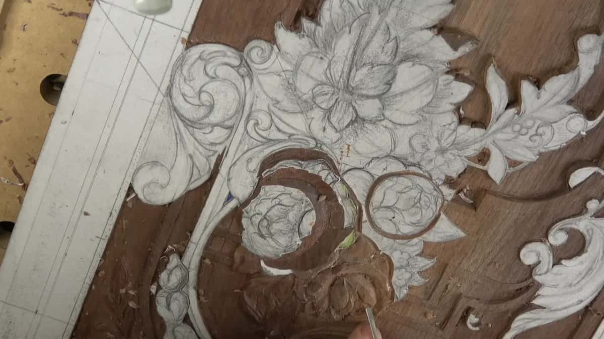 Thin blade entering from the bottom edge, the two round blooms half cut above it