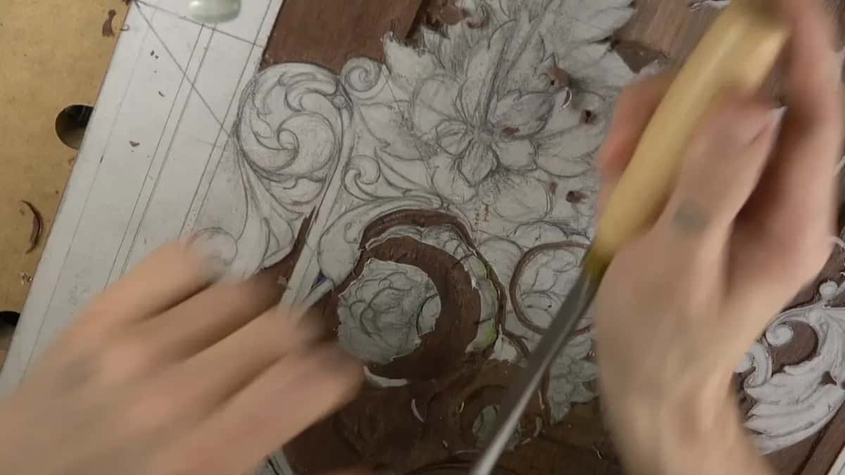 Two hands in motion, one blurred, a pale handle sweeping across the panel
