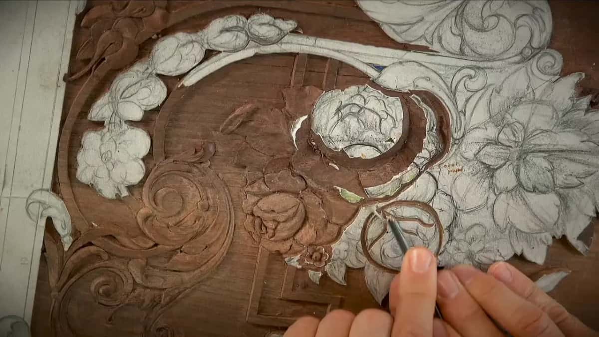 Pencil in hand at the lower right, one rose already dug out and the drawn bouquet beside it