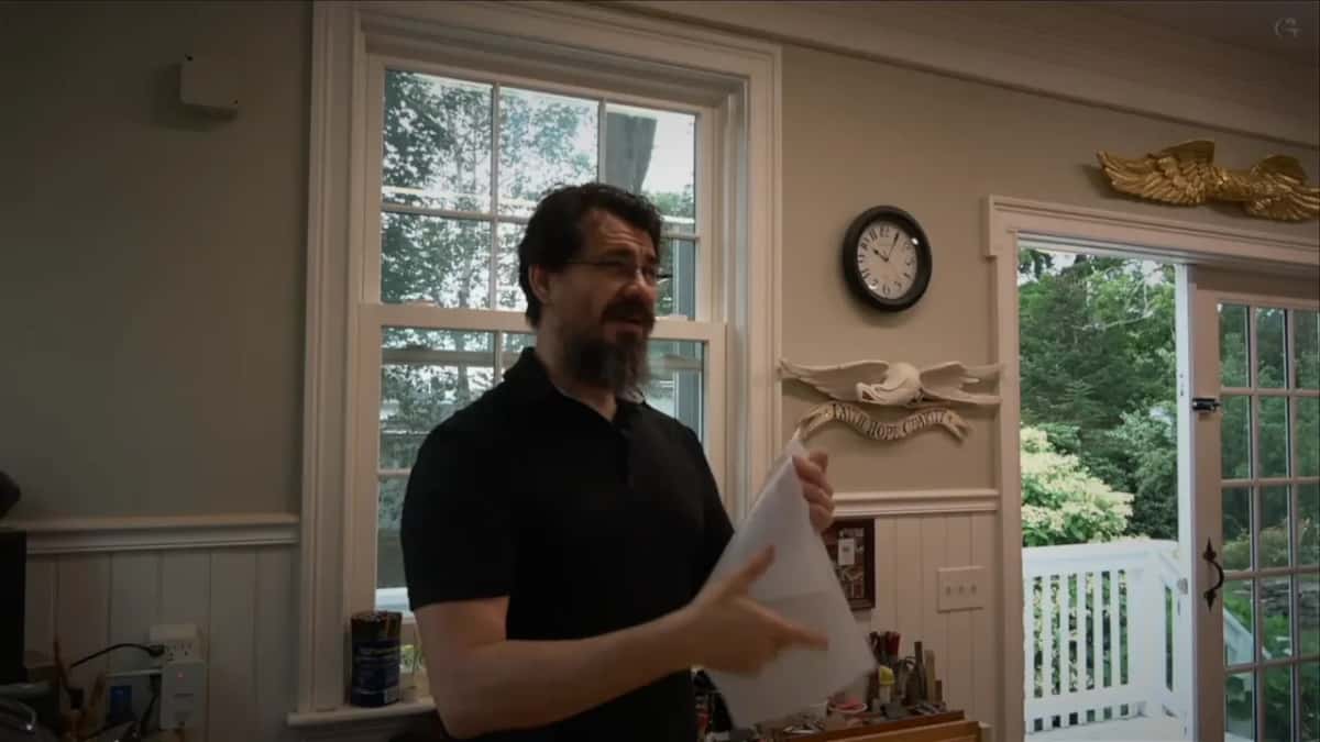 Alexander holding a sheet of clear plastic up in the Maine studio