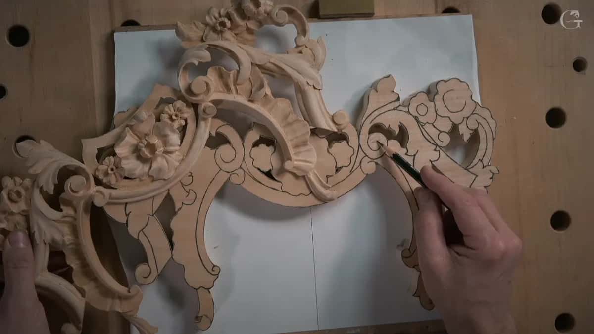 Finished half of the ornament laid beside its uncarved twin, pencil still on the second one