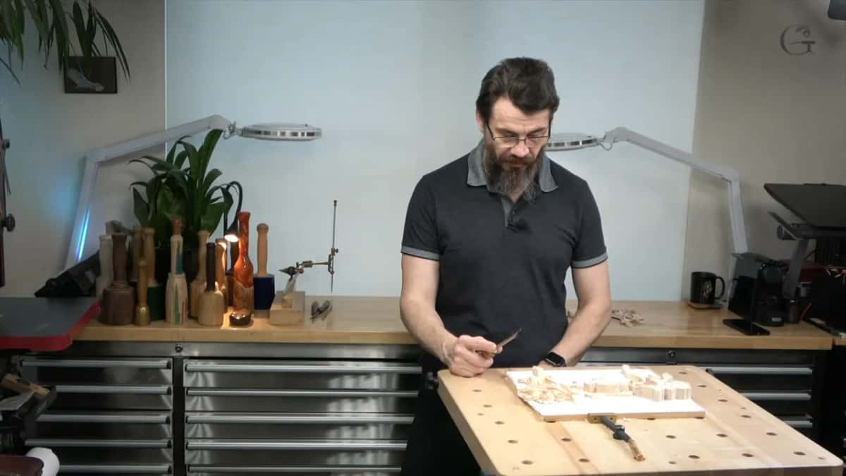 A flat bladed tool picked up for the rough shaping, though a skew or an ordinary chisel would serve just as well here