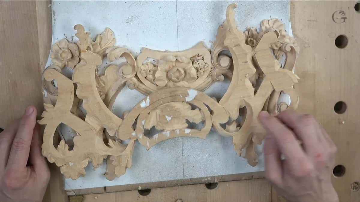 Finished piece lifted clear of its backing board and held in both hands
