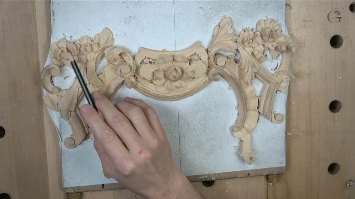 Pencil pointing out the part still to be carved