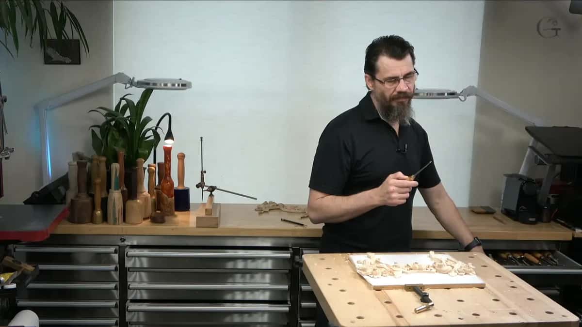Holding the quarter inch nine up to camera before he starts on the piece