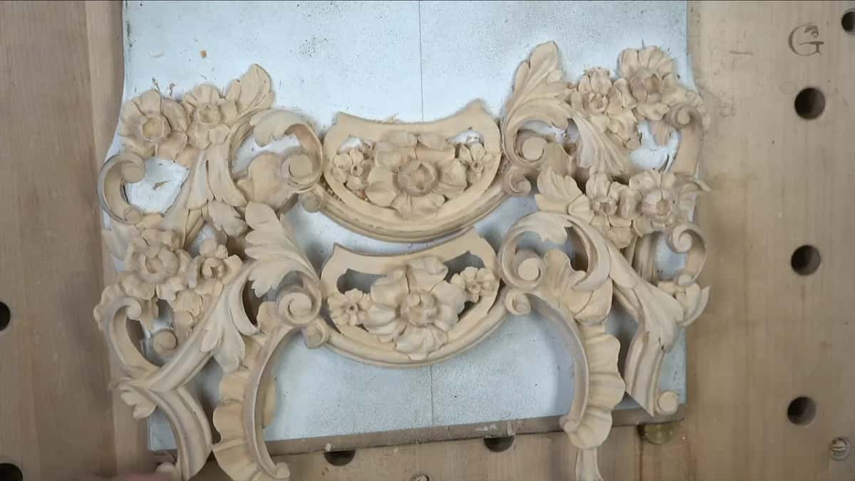 Lifted clear of its backing, the panel lying loose on the bench