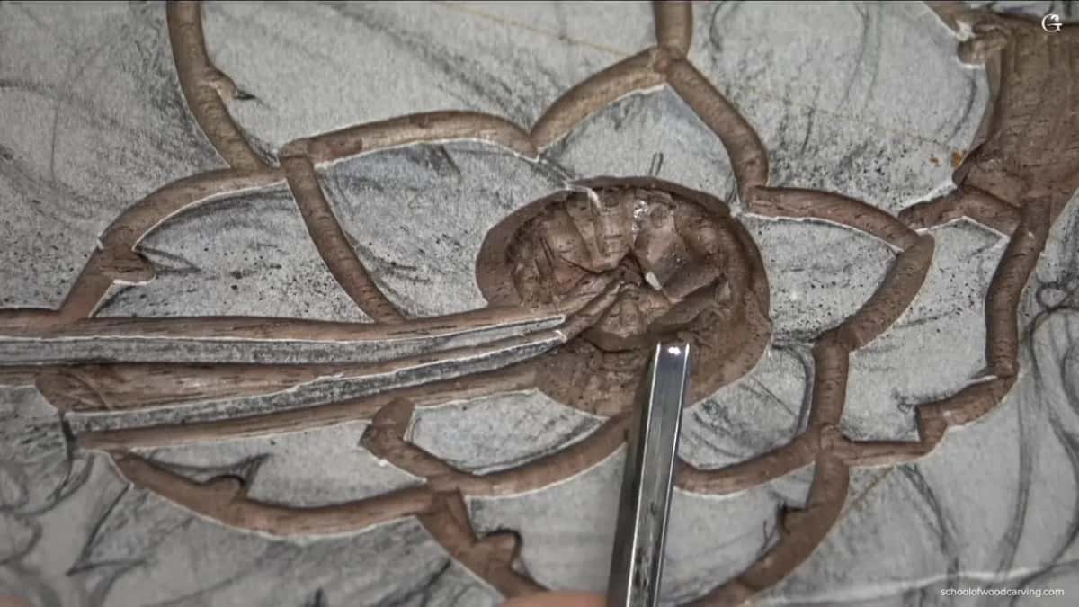 Rounded middle with the blade laid against it.
