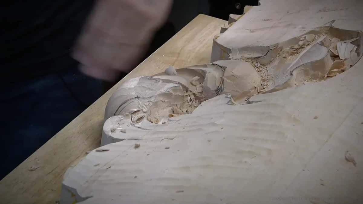 A low view along the board shows the carved forms rising