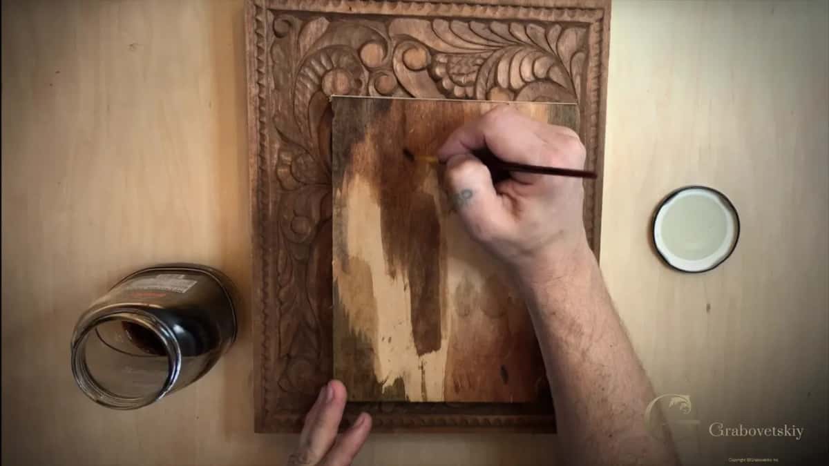 Brushing iron vinegar onto the test piece, where it goes almost black over ground that already carries natural stain.