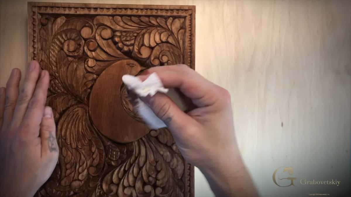 Wiping the surface back with a cloth while the stain is still wet, which lifts colour off the high points.