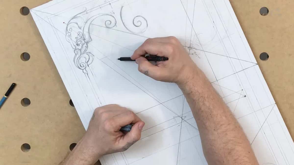 Black pencil held over open paper