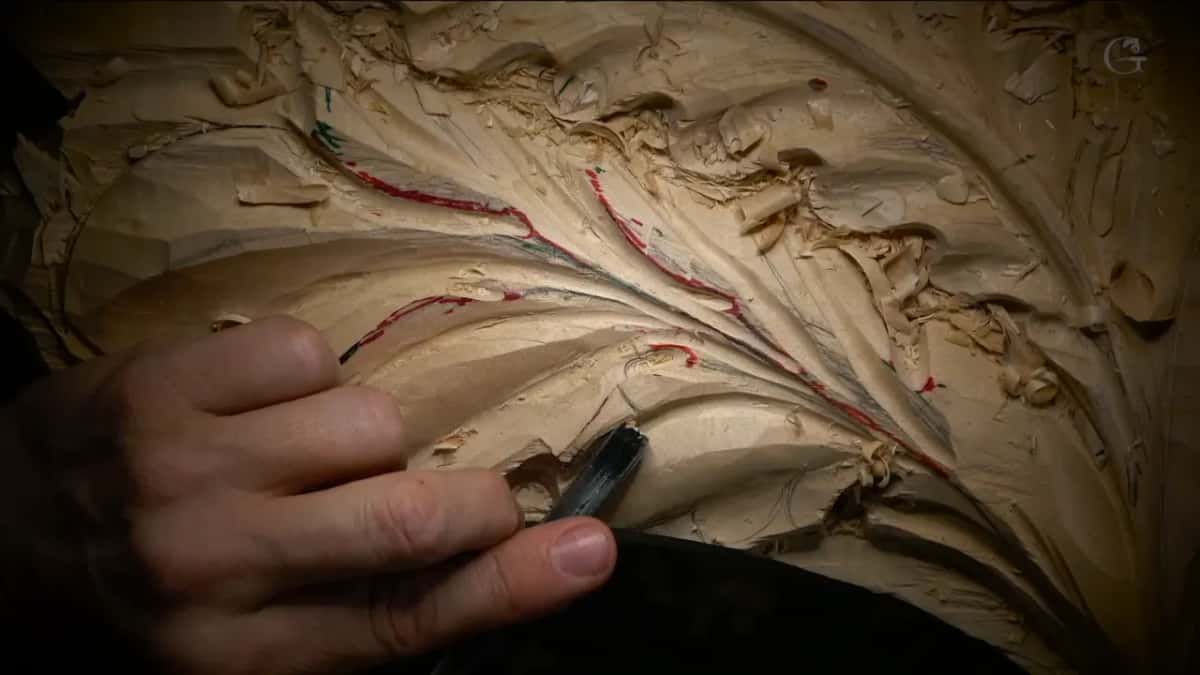 Red and green Red and green pencil lines fanning along a leaf, one hand holding it, a dark tool below