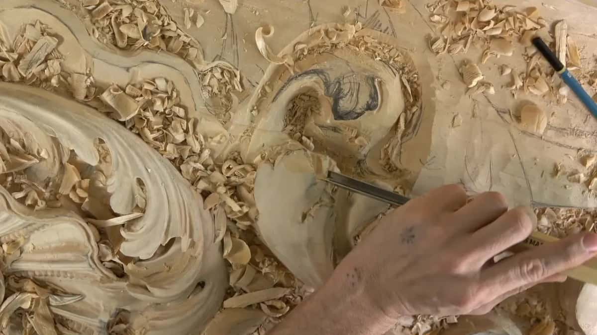 Fingers low on the steel, near the pencil marks.