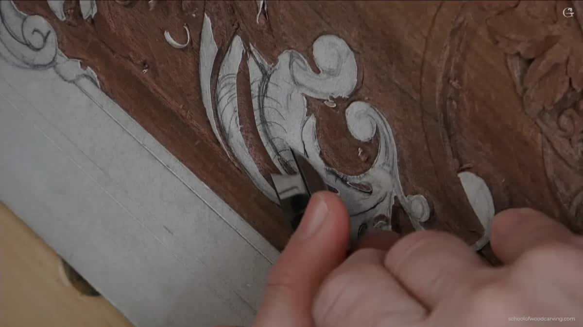 A thumb pressing the dark tool round the other way, so the good wall lands where it is wanted.