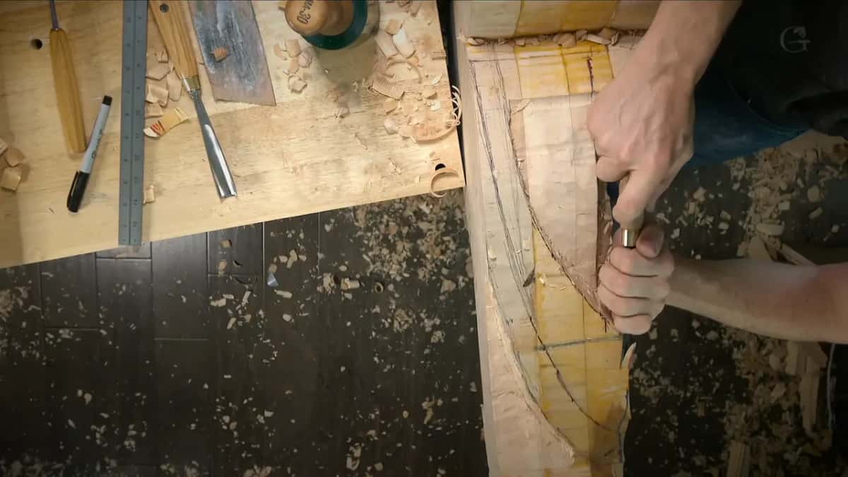 Both hands on one gouge, straight down into the corner of the block