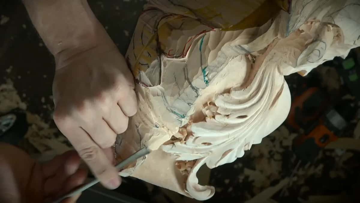 Hand pressing a narrow gouge under the carved lobes
