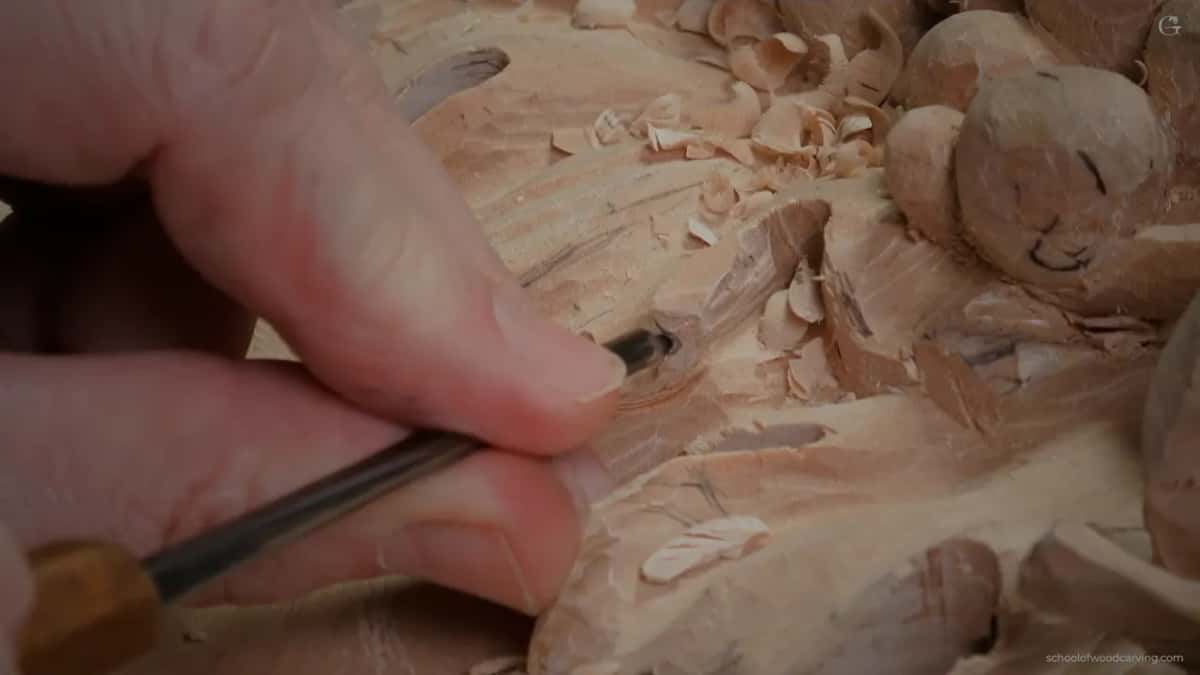 Thumb steadying a small veiner while a subdivision is carved inside a subdivision