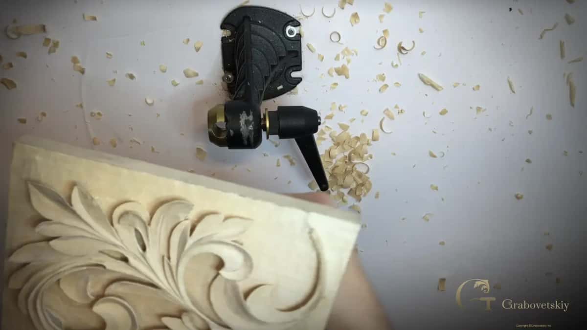 Held low in the foreground, the vise behind it empty, shavings on the white bench