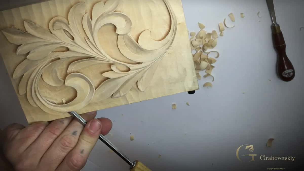 Gouge laid over at an angle near the bottom, a second tool lying at the top right