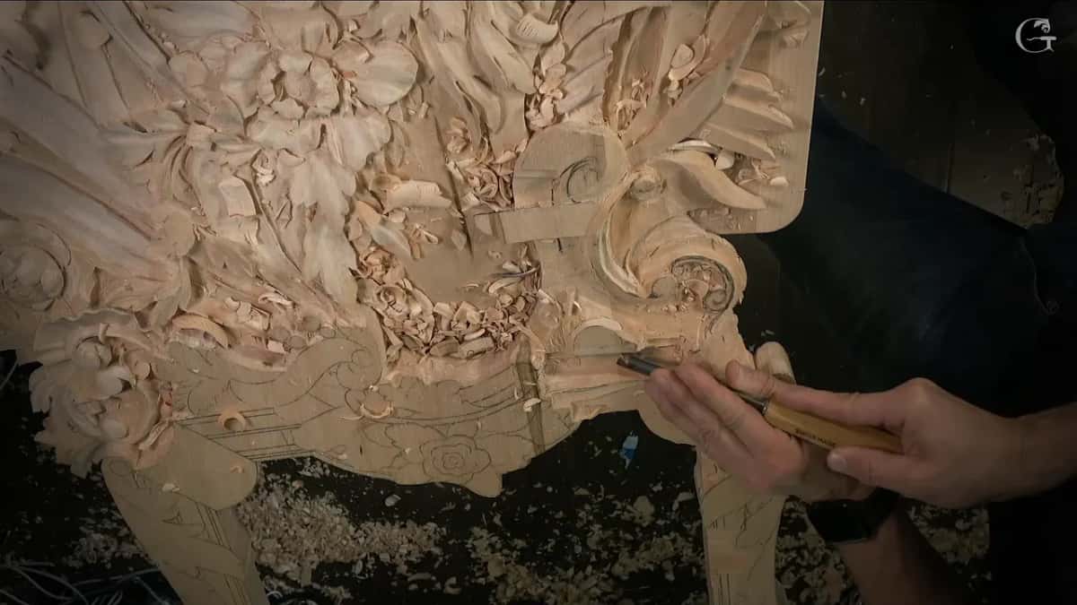 Hand with a Swiss made tool at the edge of the panel, the leg design still in pencil