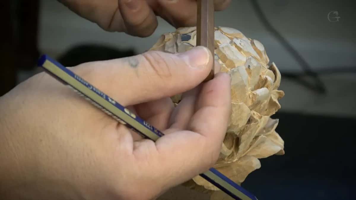 A pencil held alongside the flower, which is the thing he tells you not to use.