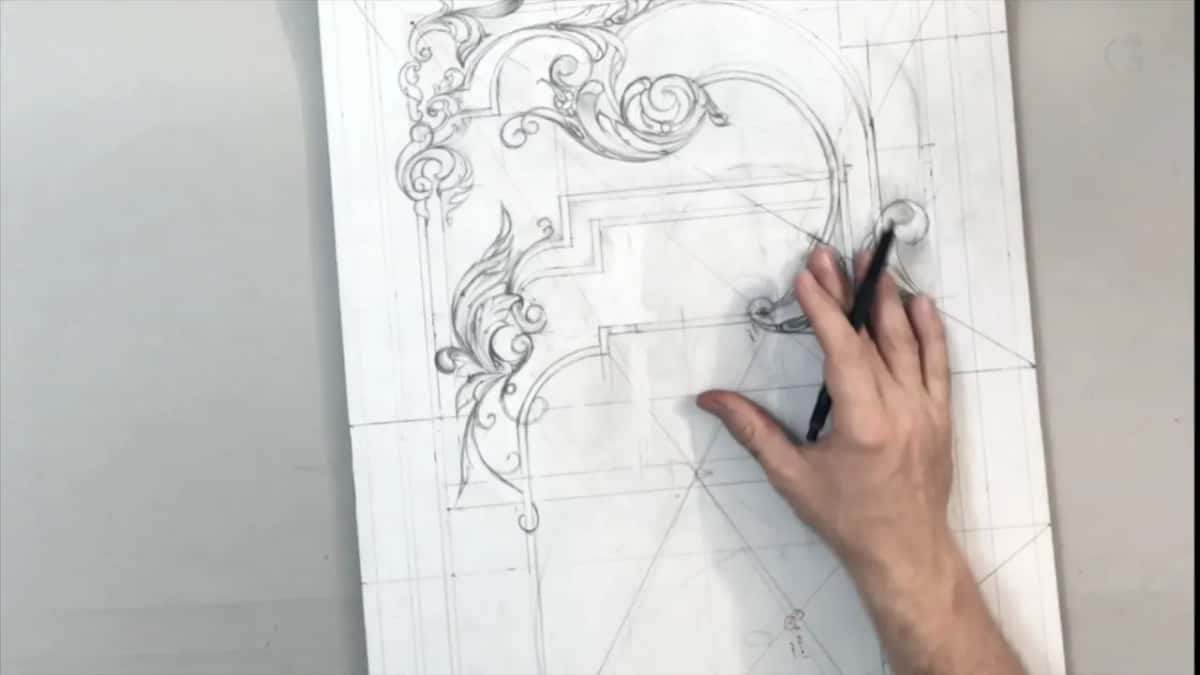Tip of a black pencil at a small curl beside the right-hand scrolls