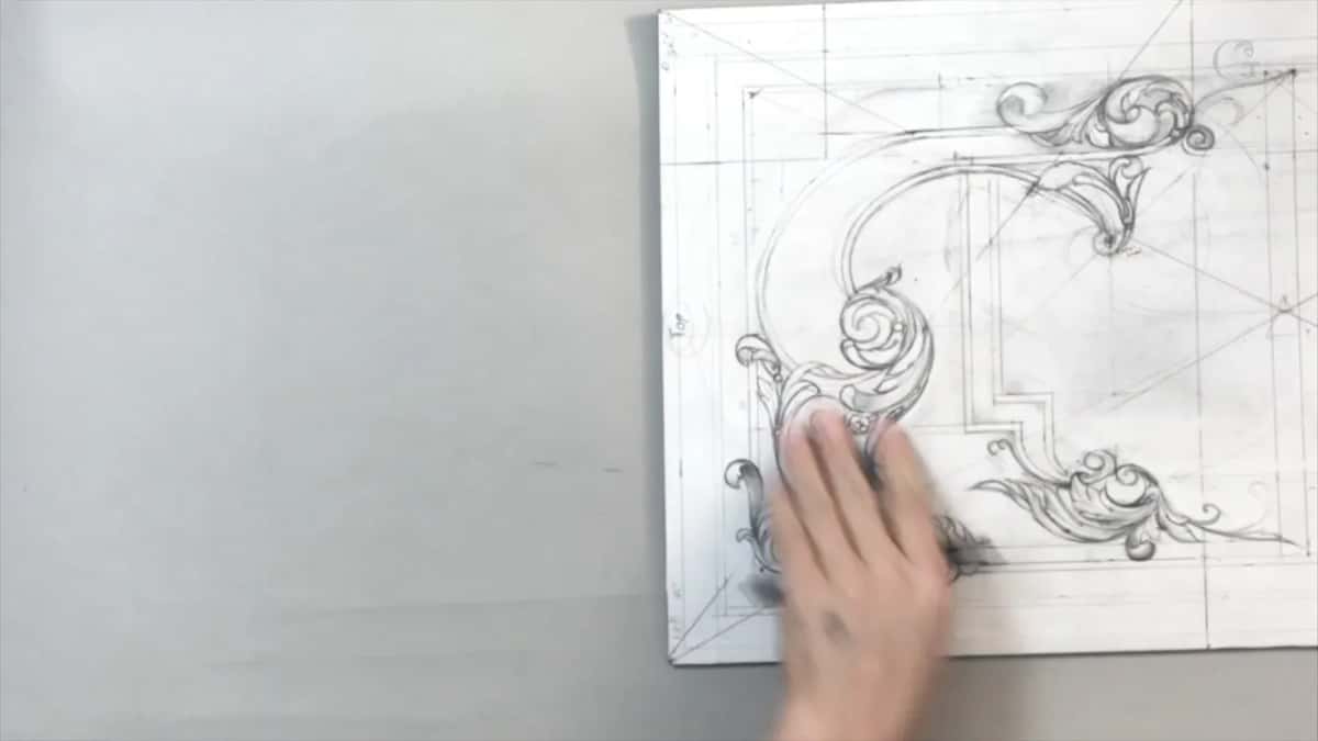 A hand sweeps across the lower left scrolls, the word Top written sideways along the edge