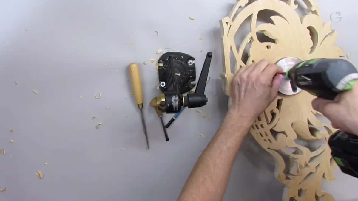 Driver going into the panel back, which is how the piece gets screwed down.