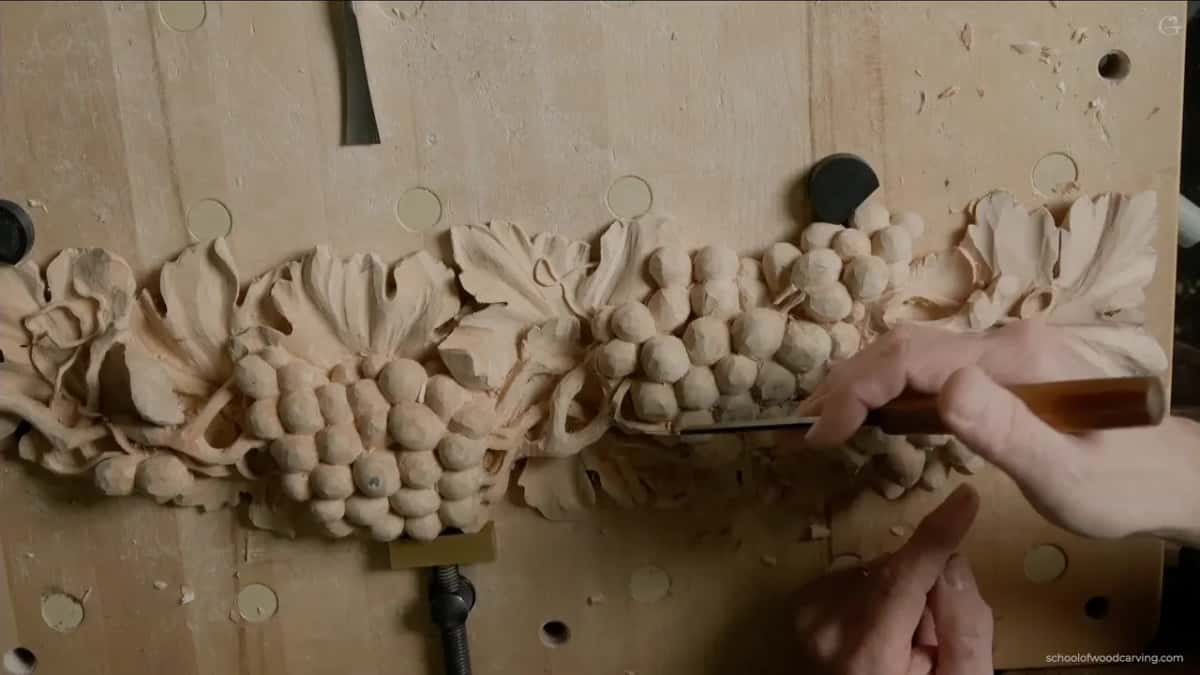 Amber handled gouge held against the nearly finished run of grapes