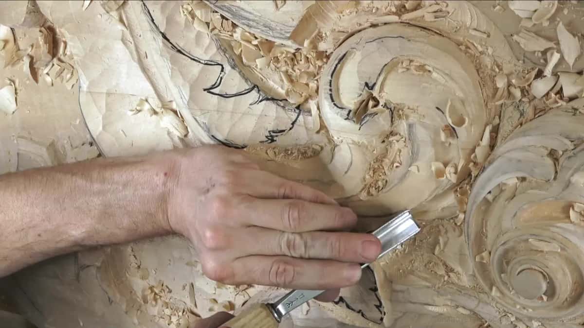 Fingers pressed flat on a wide blade.